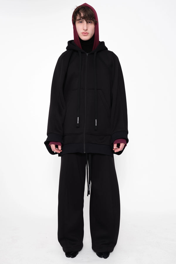 male-wearing-black-double-hood-hoodie-and-black-oversized-lounge-pants-on-white-background-full-body-front