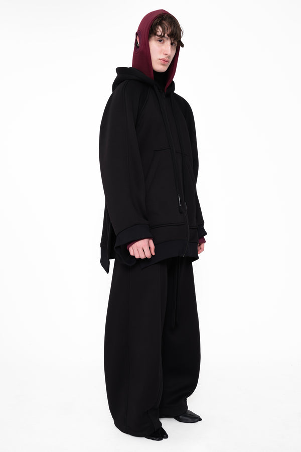 male-wearing-black-double-hood-hoodie-and-black-oversized-lounge-pants-on-white-background-full-body-three-quarter