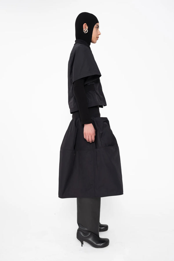 female-wearing-black-bomber-shirt-with-black-midi-skirt-on-white-background-full-body