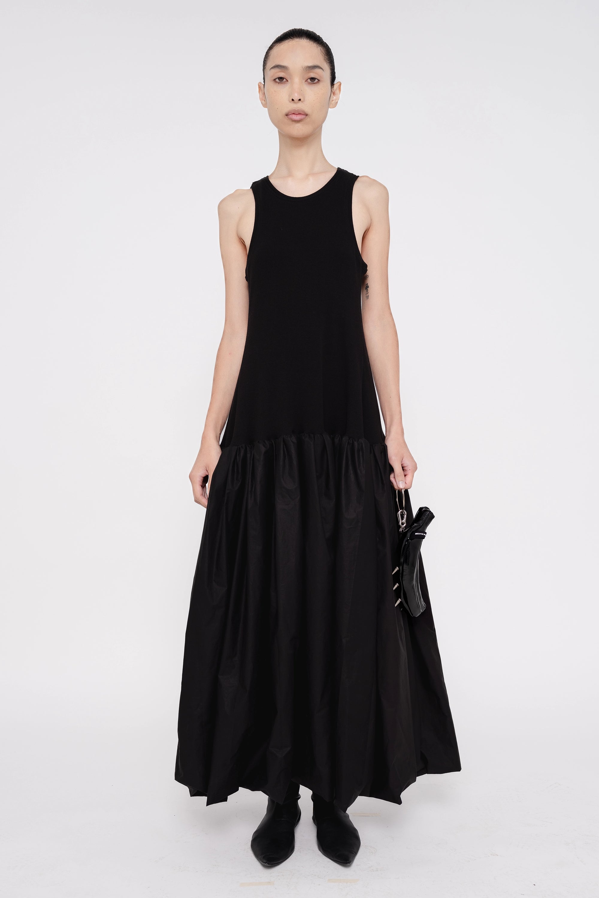 female-wearing-black-long-tank-dress-with-ruffled-skirt-on-white-background-full-body-front