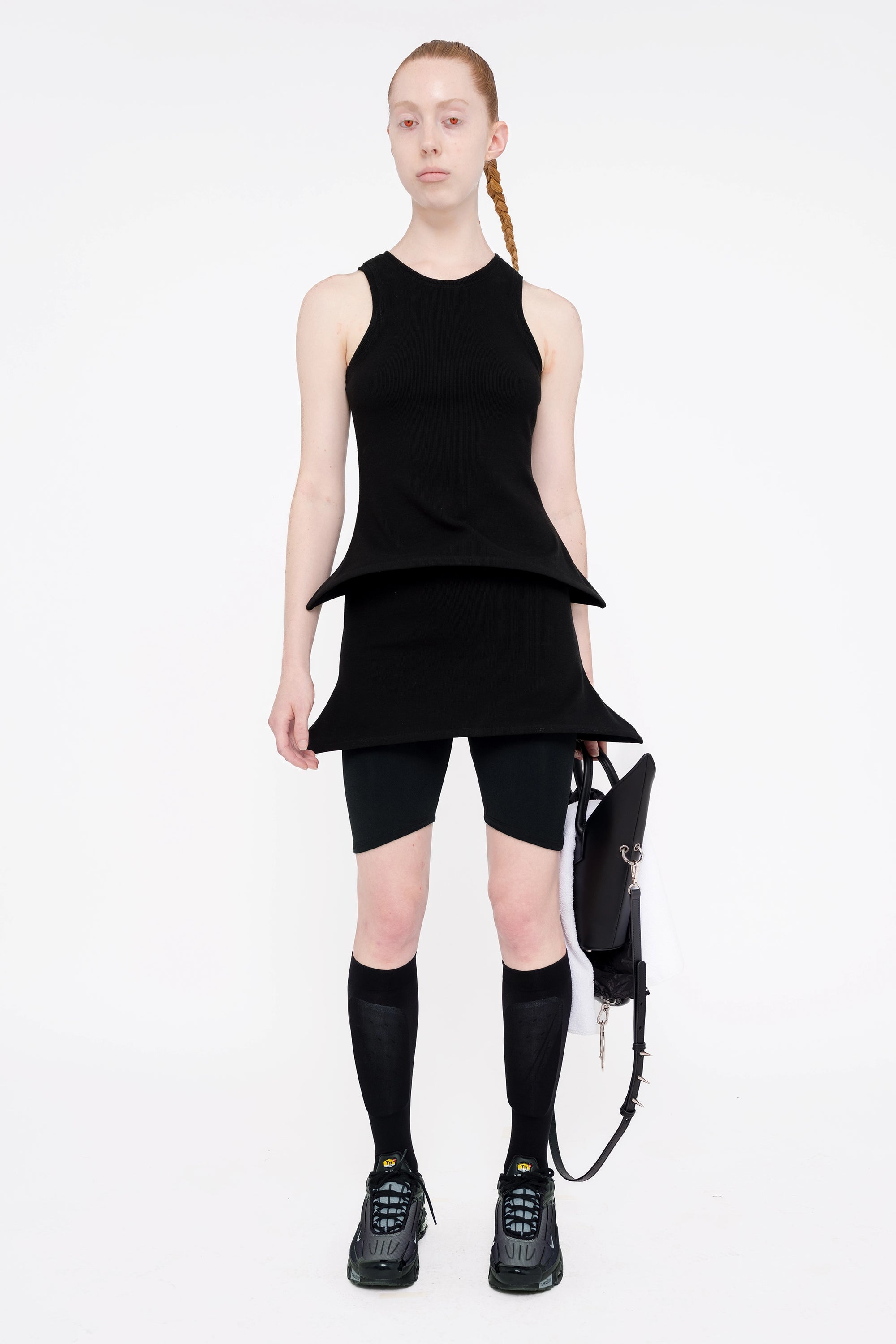 female-wearing-black-tank-top-with-pointy-hem-with-black-mini-skirt-with-point-hem-on-white-background-full-body-front